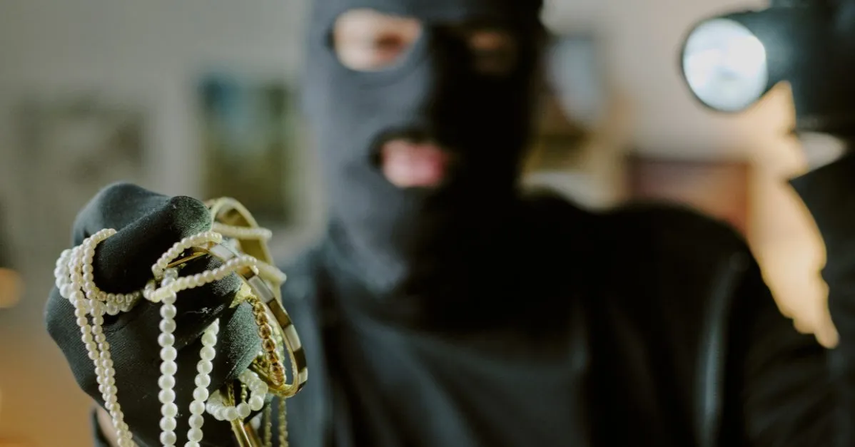 (thief holding jewelry)