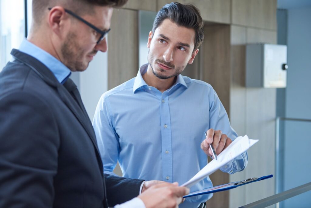 Security guard reviewing guard training records with a client